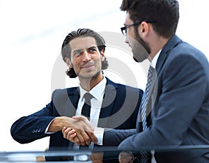 Confident handshake colleagues in the office
