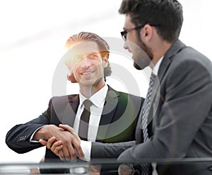 Confident handshake colleagues in the office
