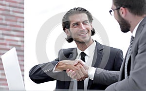 Confident handshake colleagues in the office