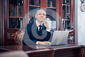 Confident handsome businessman sitting in luxury interior