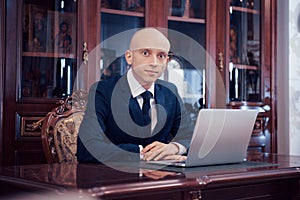 Confident handsome businessman sitting in luxury interior