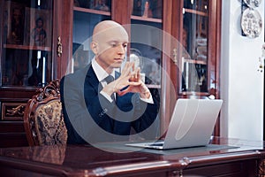 Confident handsome businessman sitting in luxury interior