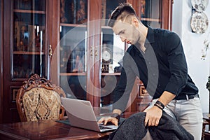 Confident handsome businessman sitting in luxury interior