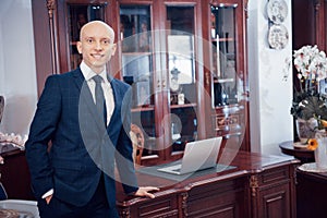 Confident handsome businessman sitting in luxury interior