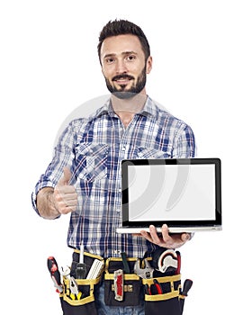 Confident handyman with laptop