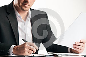 Confident happy businessman signing contract