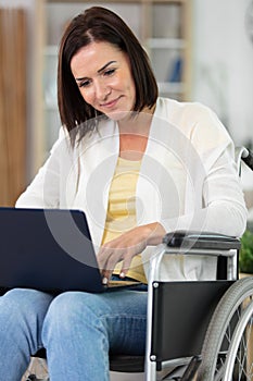 confident happy businesswoman in wheelchair working at office