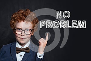 Confident happy child boy portrait on black background