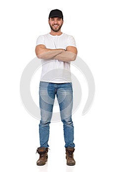 Confident And Happy Young Man Is Standing With Arms Crossed