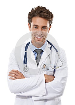 Confident healthcare professional. Studio portrait of a handsome young doctor standing with his arms crossed and smiling