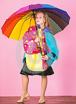 Confident in her fall garments. Waterproof accessories manufacture. Kid girl happy hold colorful umbrella wear