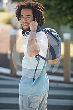 confident hipster guy crossing street