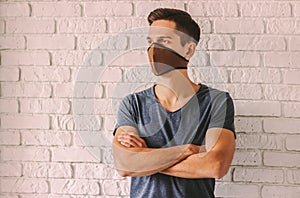 Confident hipster man in professional face mask for pesonal protection