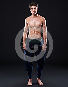 Confident about his water-sports abilities. Studio shot of a muscular young swimmer.