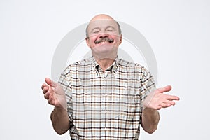 Confident hispanic mature man laughing and smiling