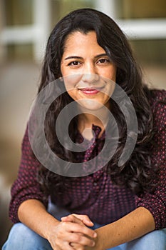 Confident Hispanic woman laughing and smiling stock photo
