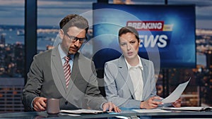 Confident hosts presenting news evening television closeup. Presenters reporting