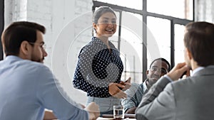 Confident indian businesswoman convincing thoughtful multiethnic business partners on negotiations