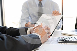 Confident insurance agent broker man holding document and present pointing showing an insurance policy contract form to client