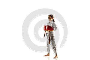 Confident junior in kimono practicing hand-to-hand combat, martial arts