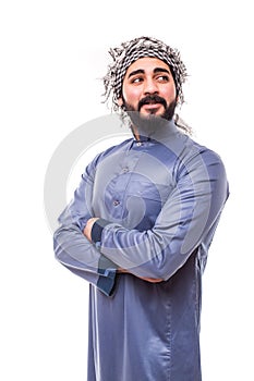 Confident khaleeji man smiling standing hands on waist wearing shemagh and thobe,  on white background