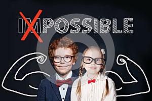 Confident kids little boy and girl with text possible on chalkboard background. Success and develop concept