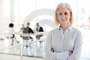 Confident lady business coach team leader posing in office, port photo