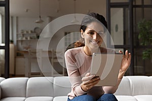 Confident latin woman hold tablet zoom in image on screen