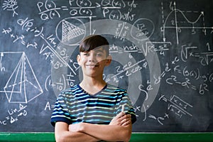 Confident Latino Boy Smiling At Camera During Math Lesson