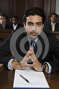 Confident Male Advocate Sitting In Courtroom photo