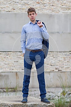 Confident male business teenager in blue suit