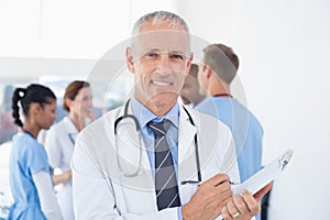 Confident male doctor smiling at camera