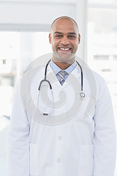 Confident male doctor smiling at camera