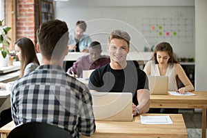 Confident male freelancer smiling at camera