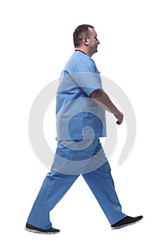 confident male paramedic striding forward. isolated on a white background.