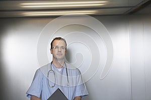 Confident Male Physician In Elevator