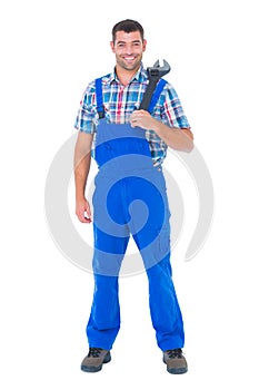 Confident male repairman holding adjustable wrench