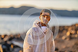 Confident male scientist or health worker standing at beach