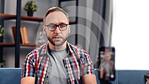 Confident male vlogger public speaker talking live broadcasting record video on smartphone screen