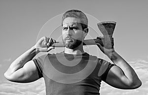 confident man with axe. caucasian woodsman man hold ax. brutal man on sky background