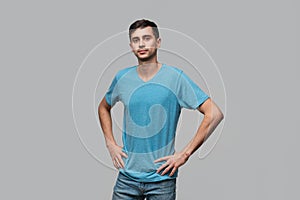 Confident man in a blue tee lookning at the camera. Concept of confidence