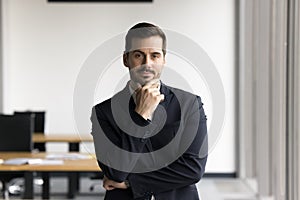 Confident man in business suit standing in office photo