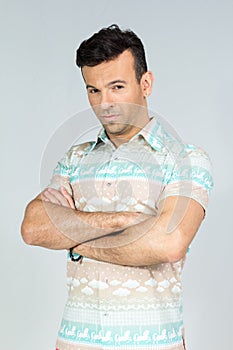 Confident man with crossed arms. Handsome brazilian male wears c