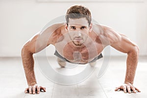 Confident man doing push-ups.