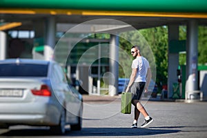 Confident man finally found petrol station and fill canister.
