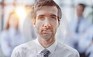 Confident man posing in front of his colleague during a meeting