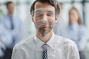 Confident man posing in front of his colleague during a meeting