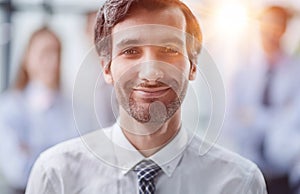 Confident man posing in front of his colleague during a meeting