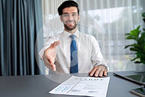 Confident man reach his hand for hand shake during job interview. Fervent