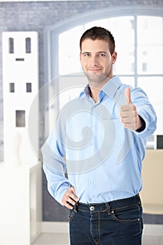 Confident man smiling thumb up